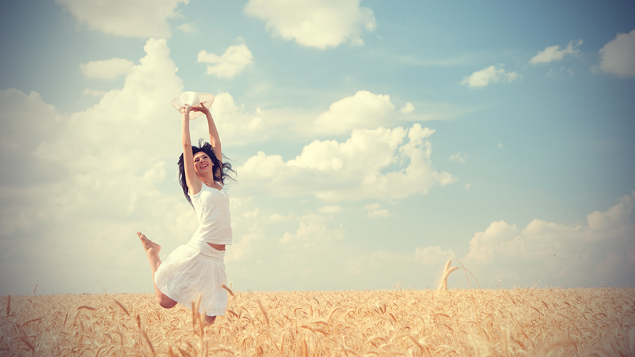 happy-woman-jumping-in-golden-wheat