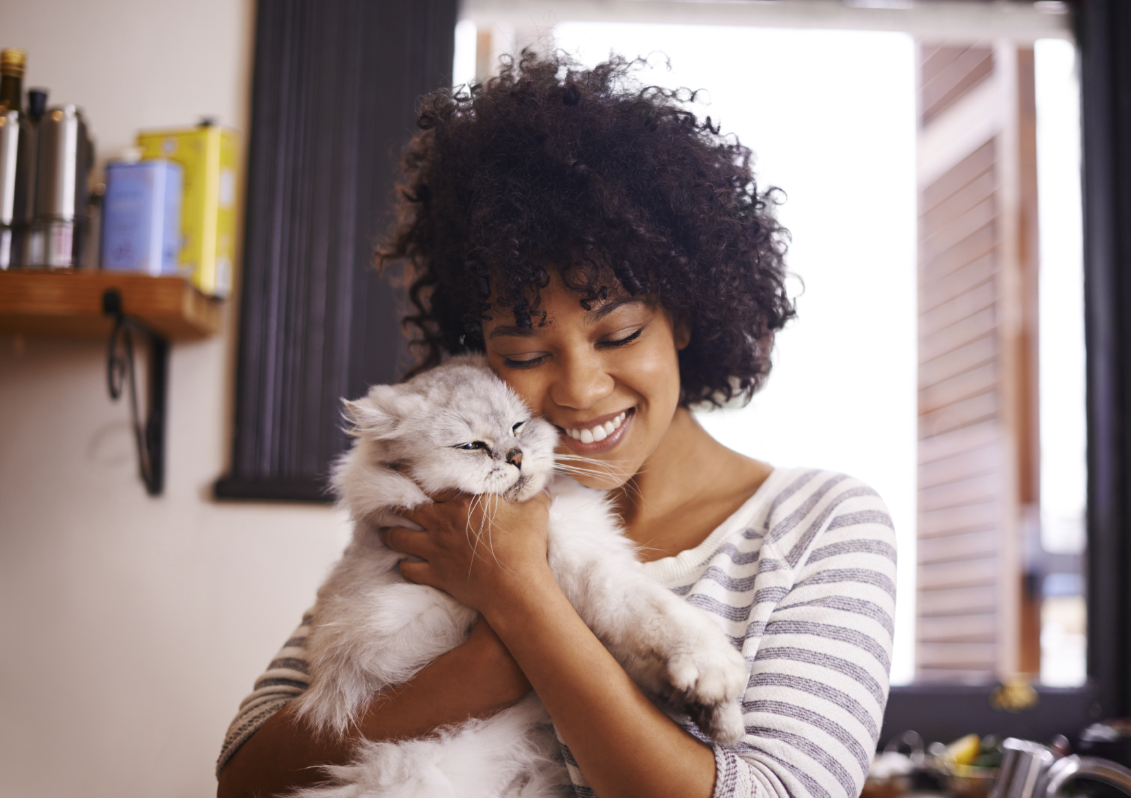 Shot of a beautiful young woman enjoying a cuddle with her cat