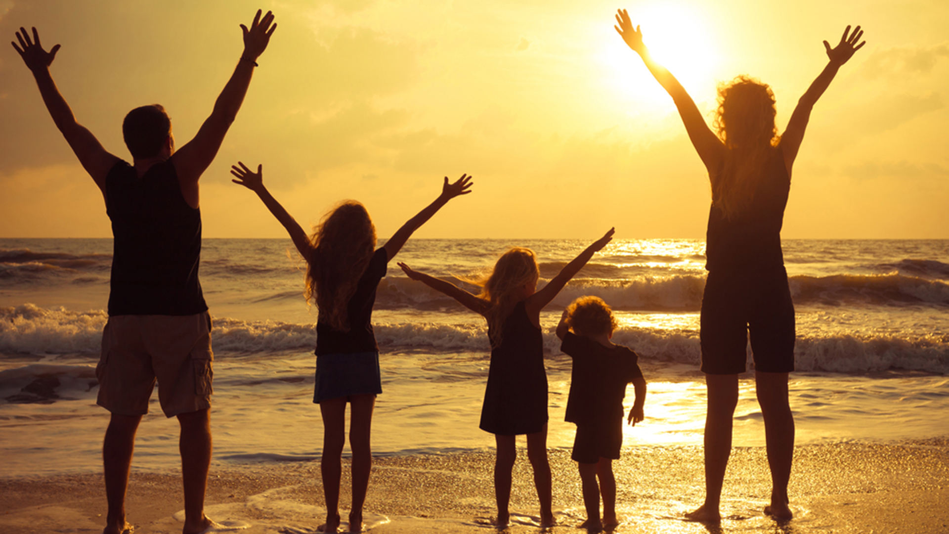 Happy family standing on the beach on the dawn time; Shutterstock ID 132280652; PO: david-today